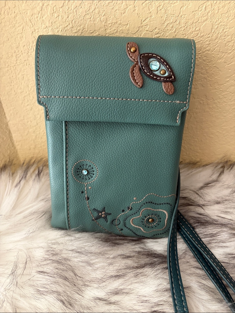 Chala RFID Teal Crossbody Bag with Floral, turtle and star accents.